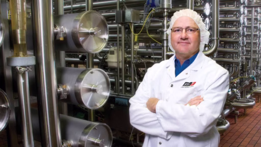 scientist with arms folded in factory