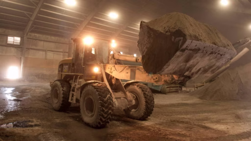 truck lifting piles of ashes