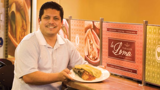 ethnic man holding a tamale