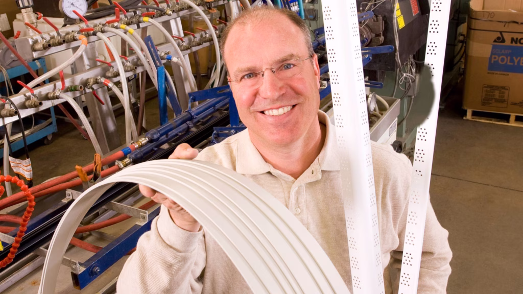 man holding wound up strands of plastic