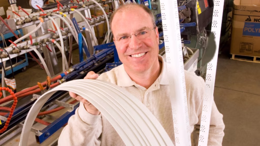 man holding wound up strands of plastic