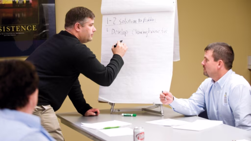 man using marker on a large paper