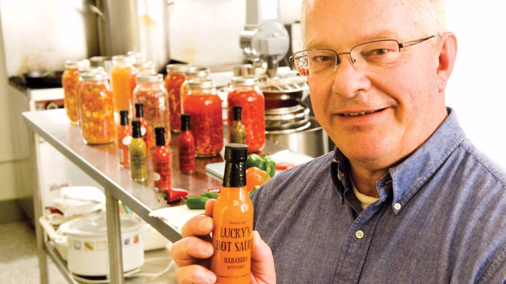man holding a lucky sauce container