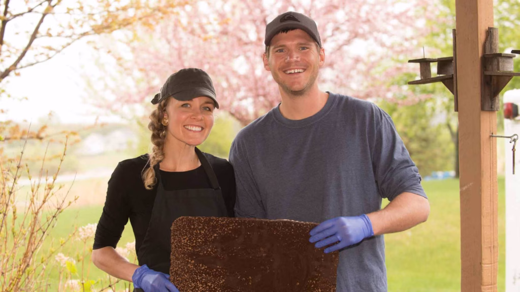 terroir chocolate owners holding large chunk of artisan chocolate