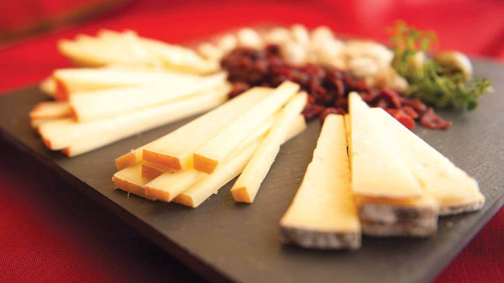 sliced cheese on a wooden board