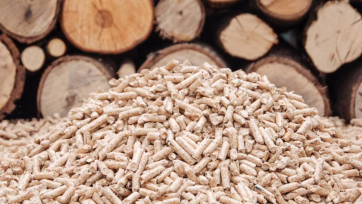 stack of wood with pile of pellets in front