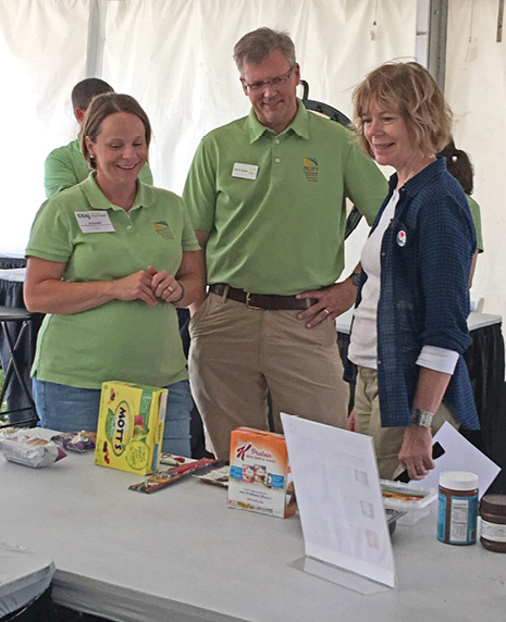 Lt. Governor Tina Smith (right) learns about AURI's food projects from Meats Scientist Carissa Nath (left) and Michael Sparby, senior project strategist (center).
