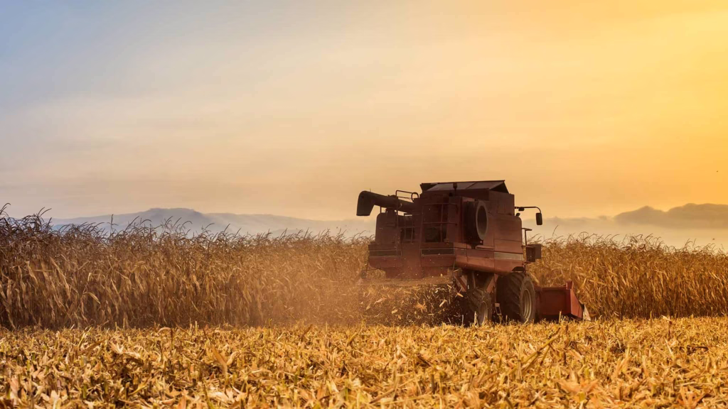 tractor in field at sunset