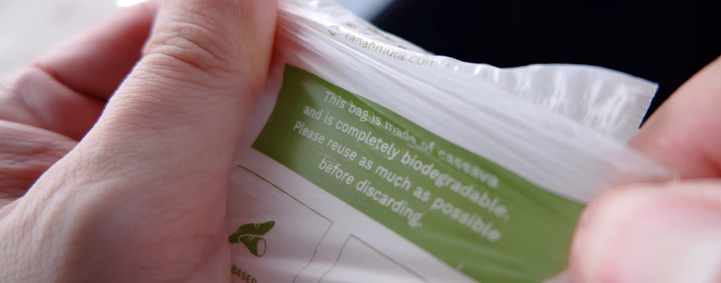 Person stretching a biodegradable plastic bag.